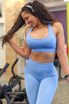 Model wearing light blue sports bra