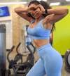 Fitness model wearing light blue sports bra